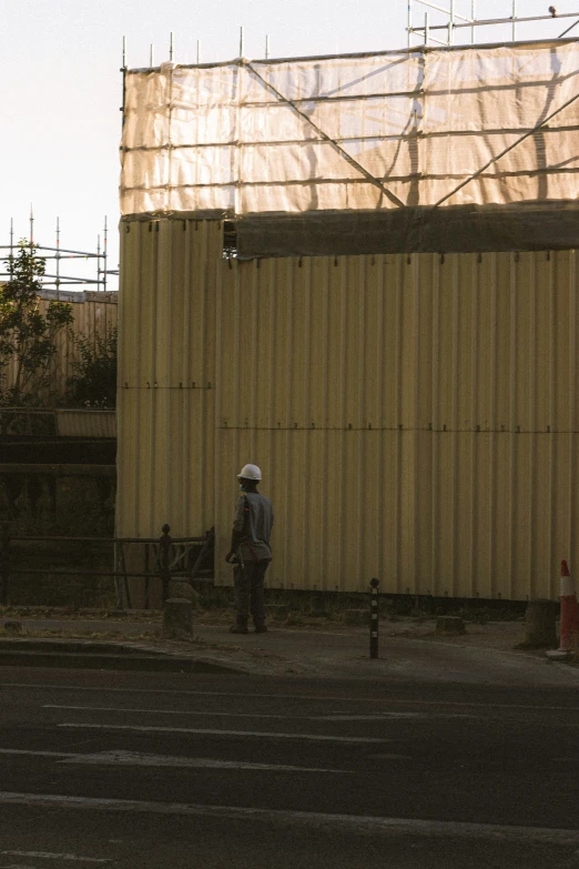 a man standing in a parking lot next to a building