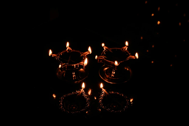 some tiny candles with orange glow lit up in the dark