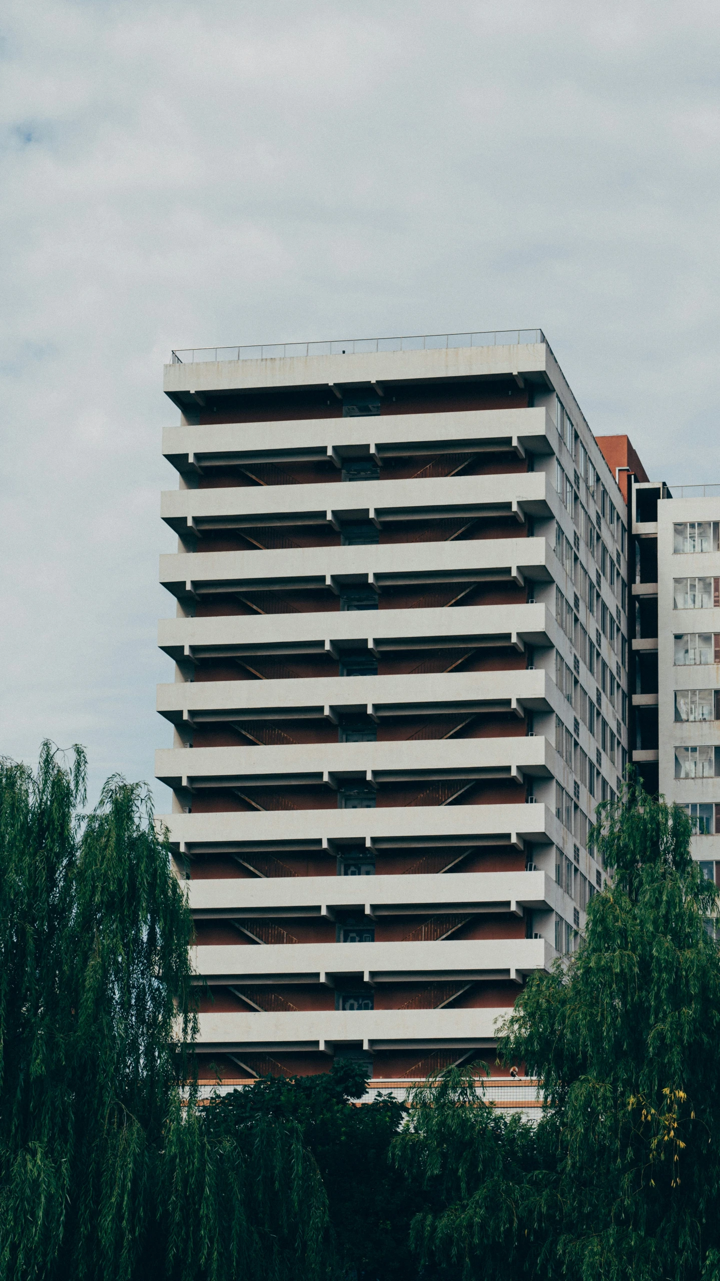 two buildings are against a cloudy sky