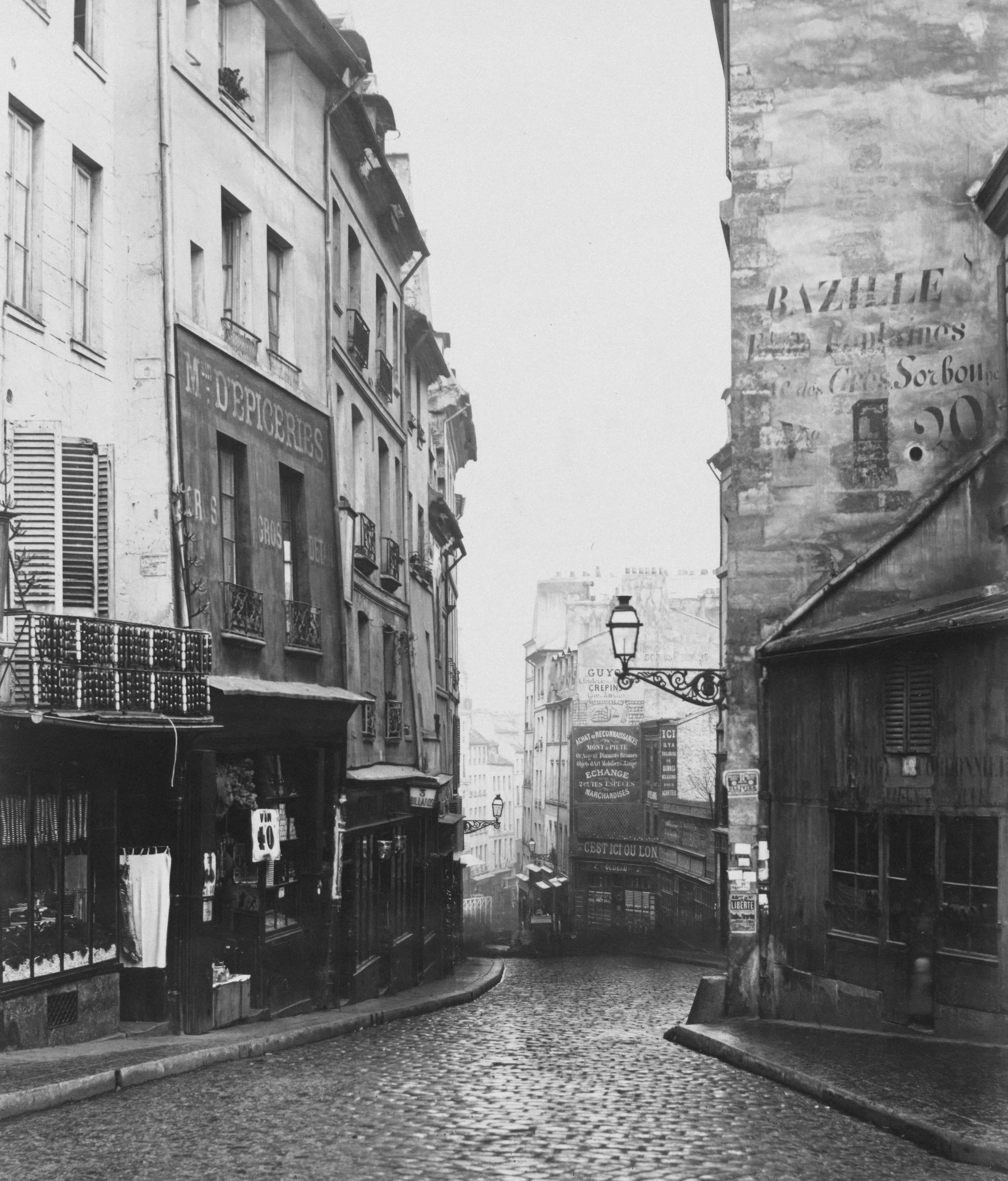 an old black and white picture shows narrow city streets