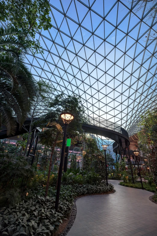 a large building with a glass roof and walkway in front