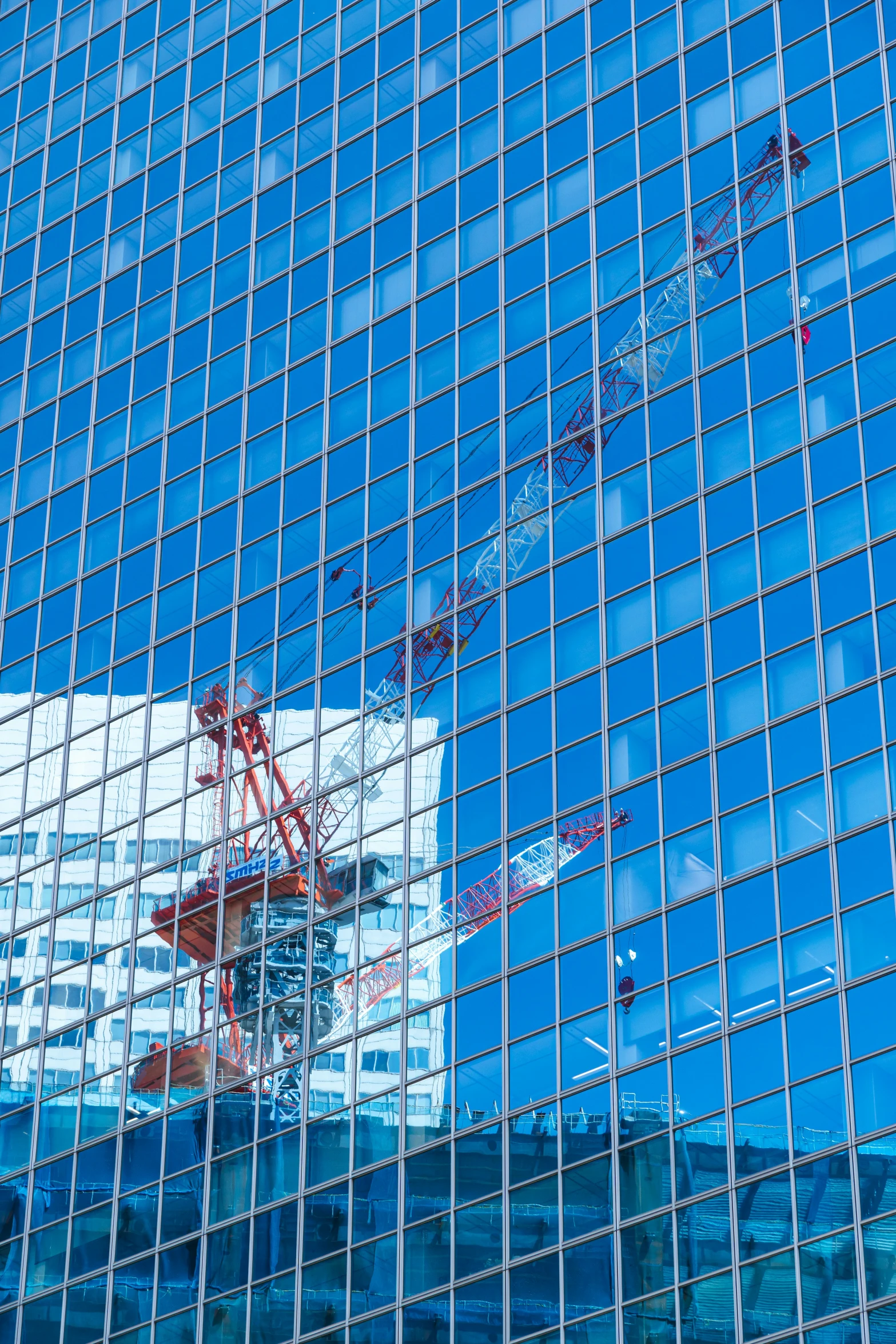 an image of a skyscr being reflected in another building's glass