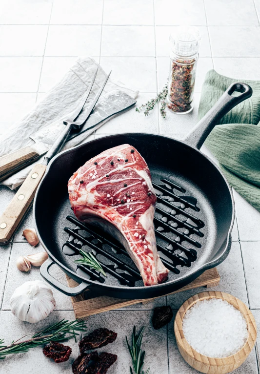 a steak cooked in a frying pan with the lid up