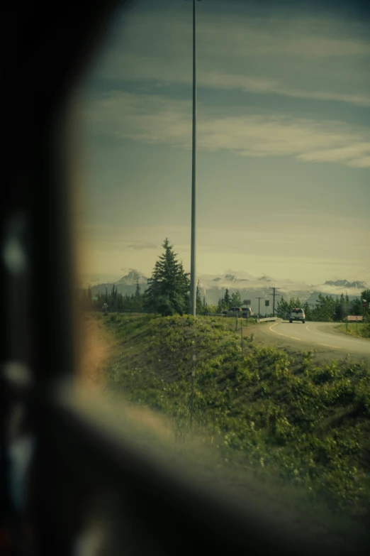 a view through the window of a car to a field