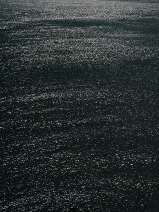 a view of a dark sea with small ripples