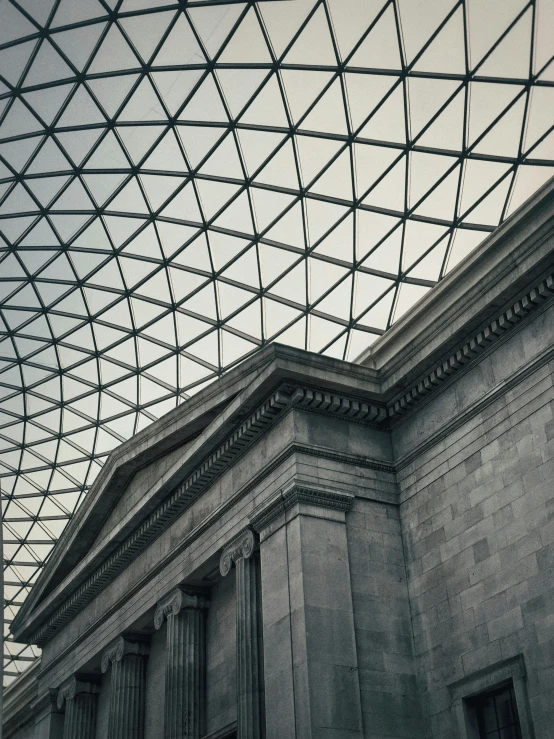 an old - style building is pictured under a glass roof