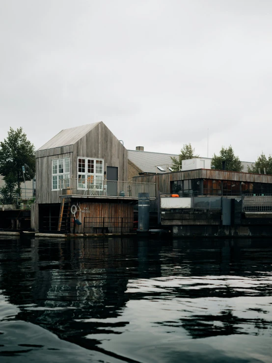 an old dock with a wooden house on it