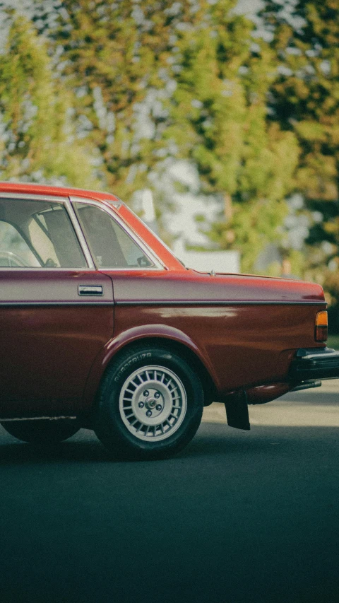 an old red station wagon parked on the street