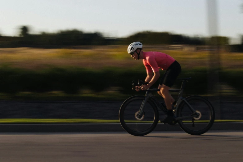 the rider is wearing a helmet on the bicycle