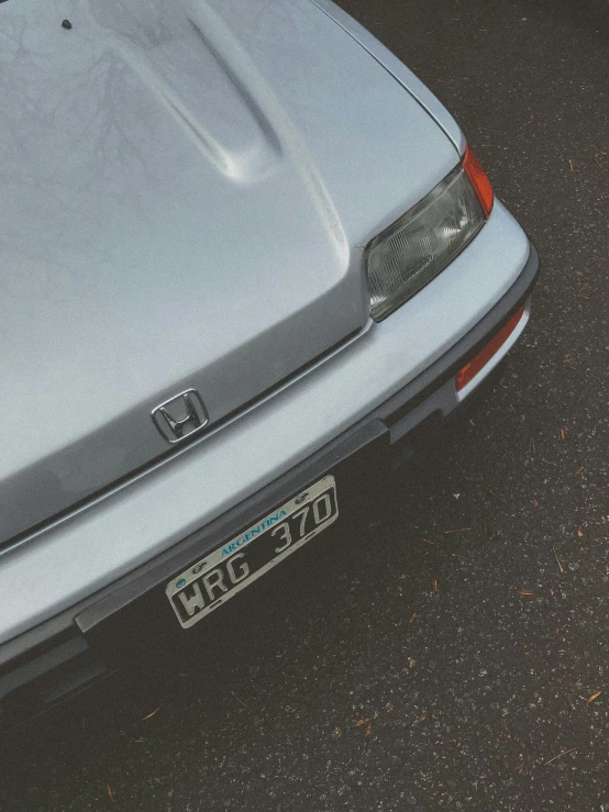 the back end of an older car with the number plates on