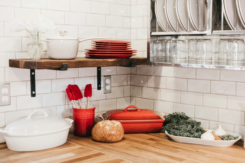 a kitchen with dishes and utensils on the shelves