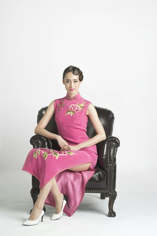 an image of a woman in pink dress sitting on a chair