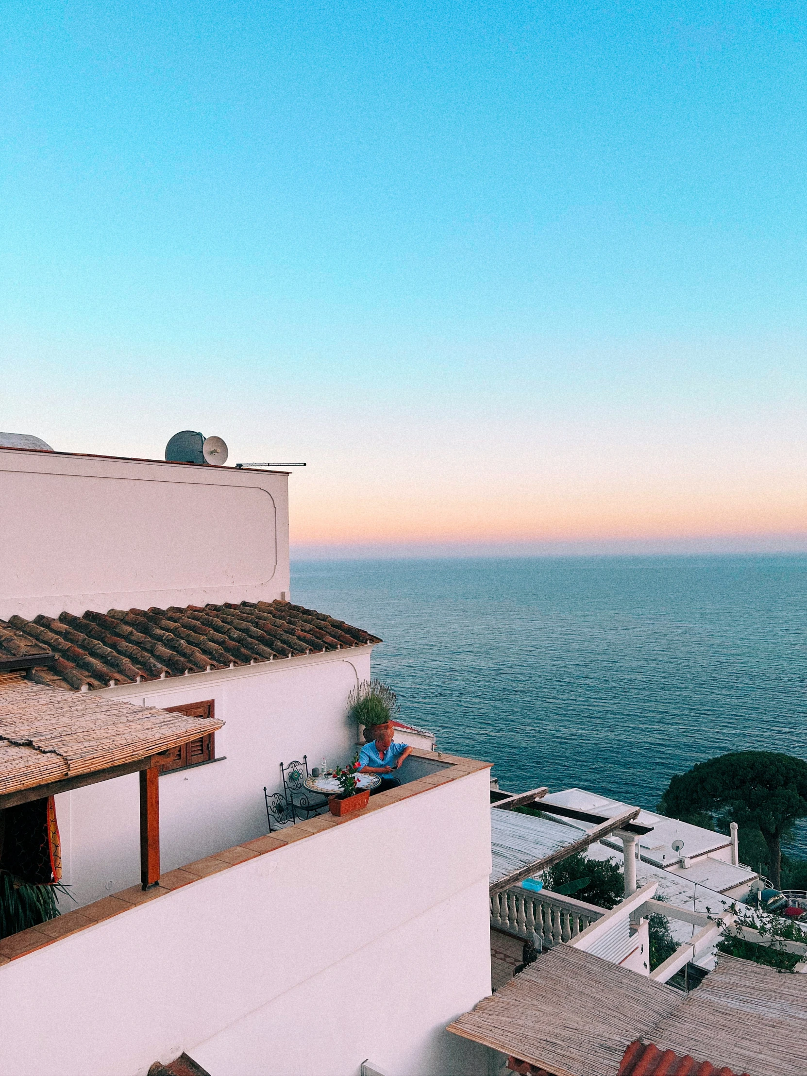 the view of the ocean, a building and the sea from above