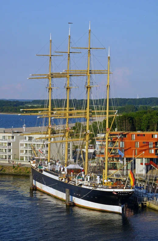 a large sail boat floating through a harbor