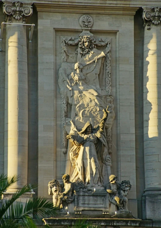 a statue of jesus holding a child near a building