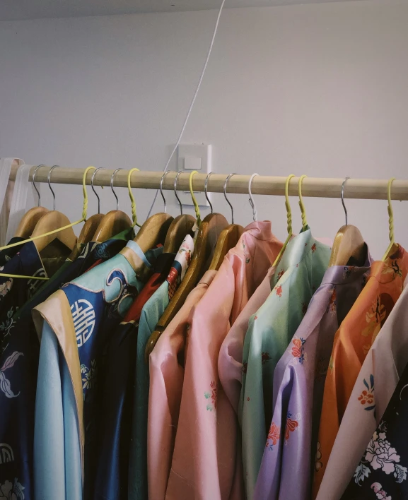 several shirts hanging on a clothes line while hung up