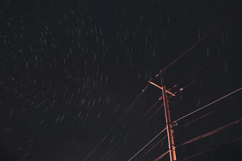 a telephone pole and the sky are all over