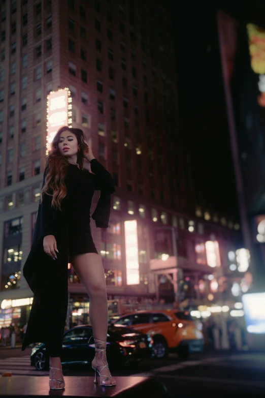 a women is posing in a city in a short dress