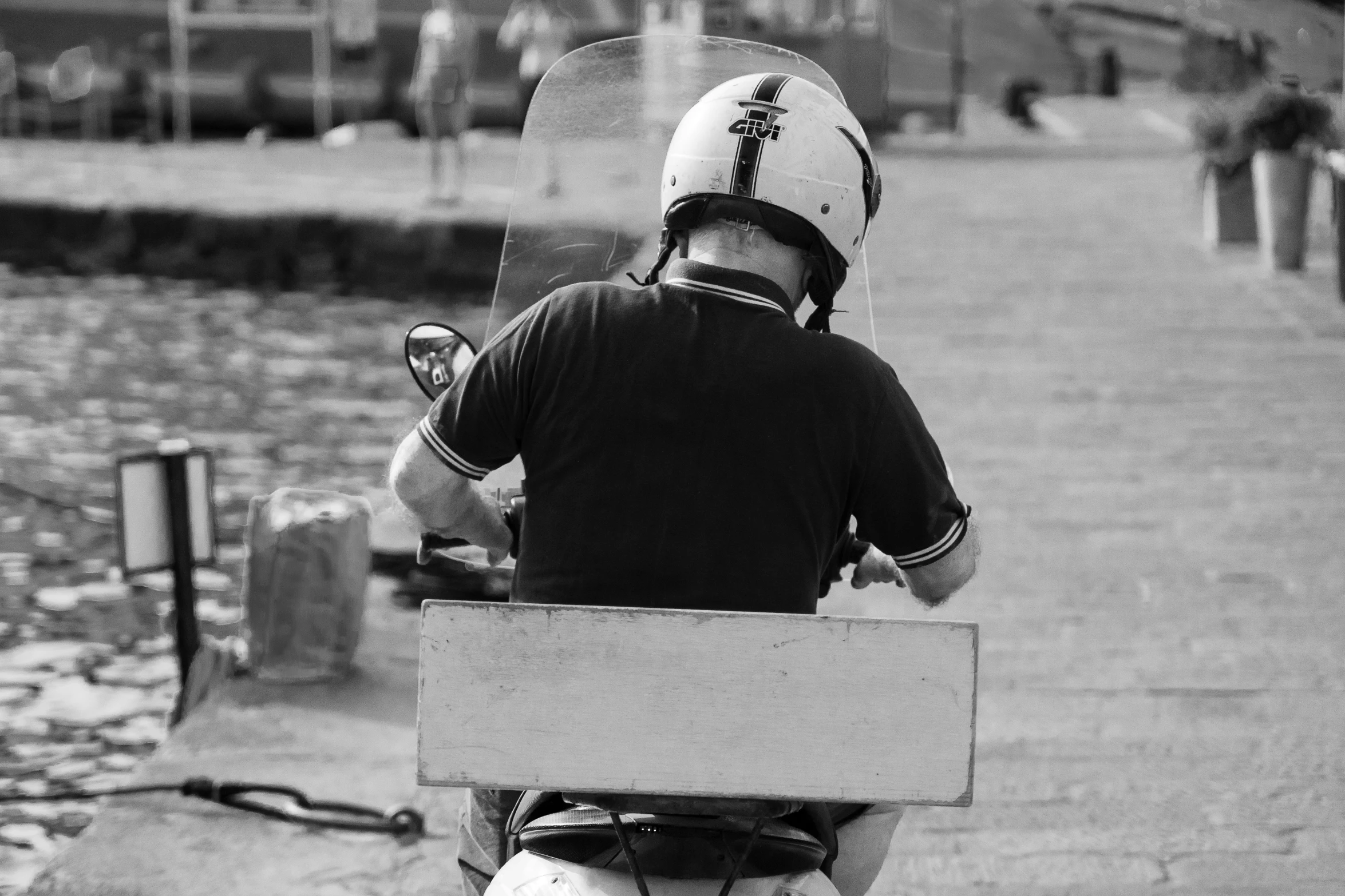 a man riding a scooter with an open top