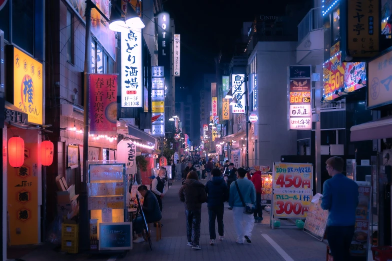 people walking down an asian street at night