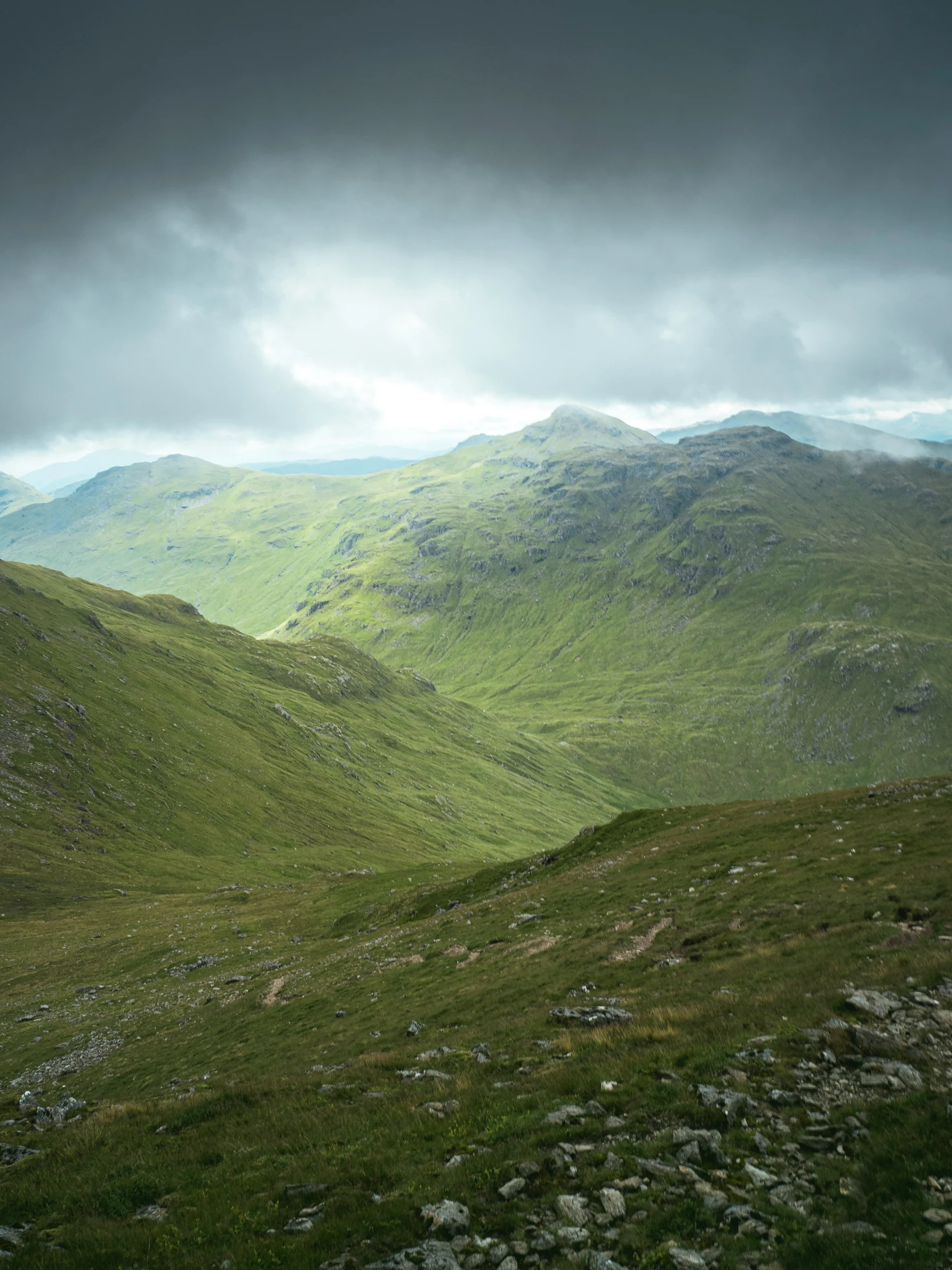 a group of people walking in a mountain area