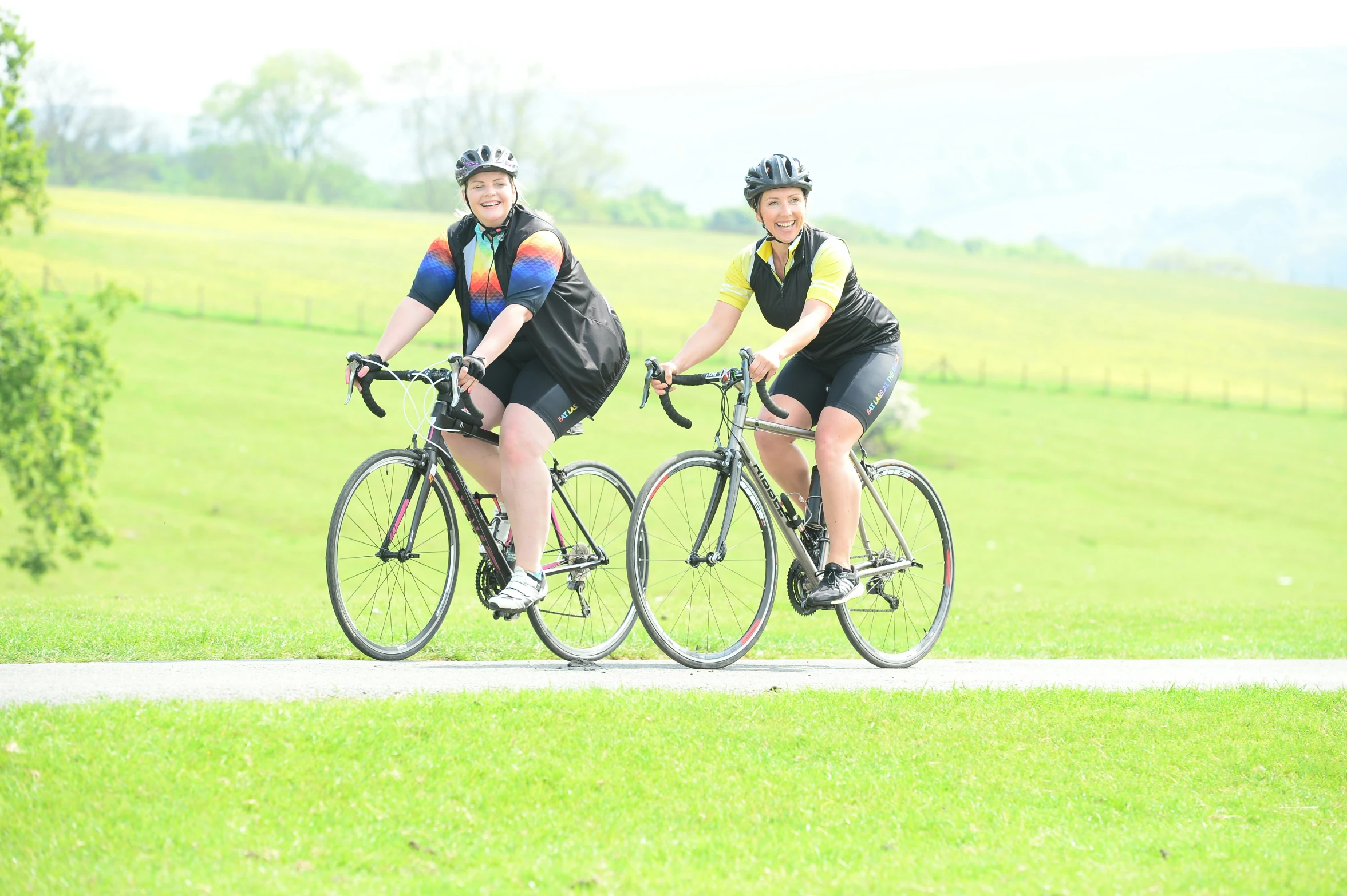 the couple are riding their bikes down the road