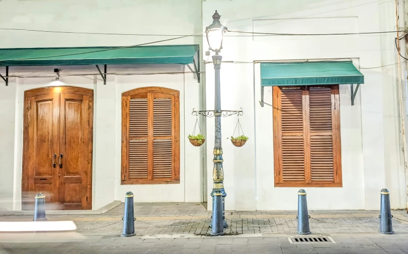 an old white building with some nice wooden doors