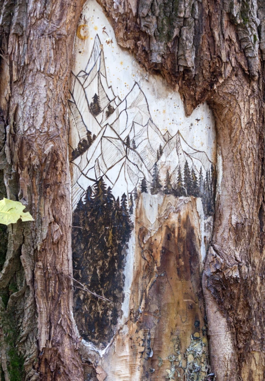 an old tree has been painted with trees and a birdhouse on it