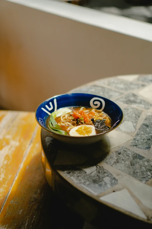 a bowl filled with soup on top of a table