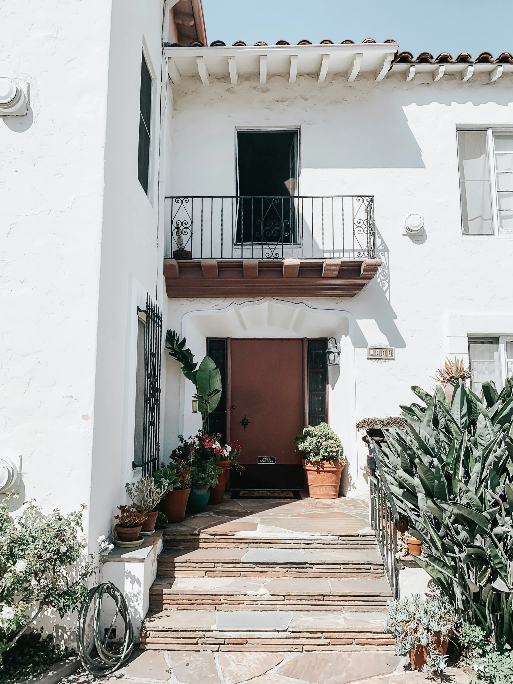 a large building with potted plants and steps