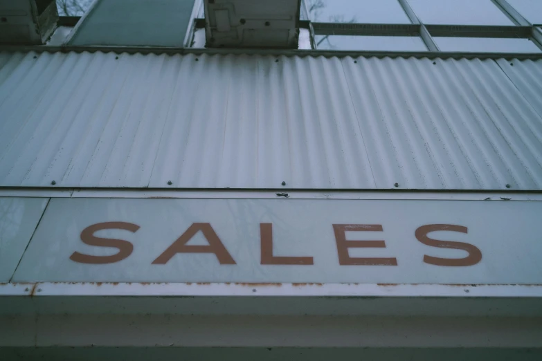 a metal store sign that reads sales on it