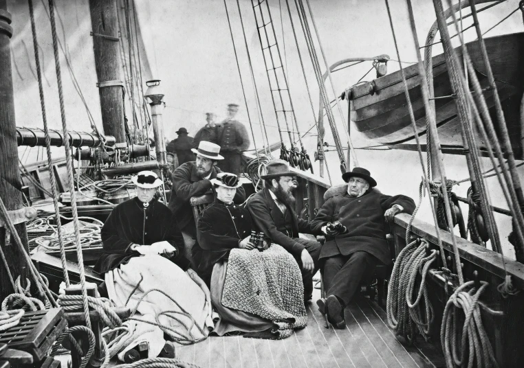 men sit on the deck of a boat