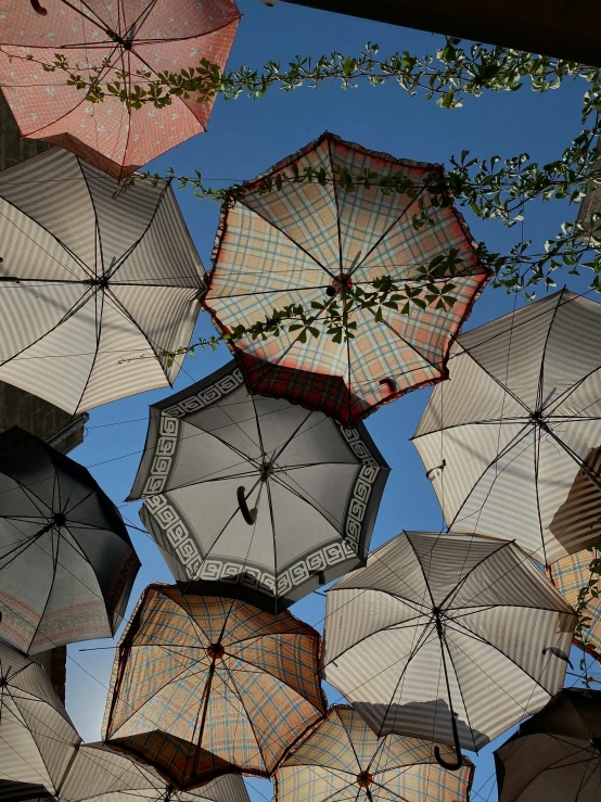 many umbrellas that are hanging in the air