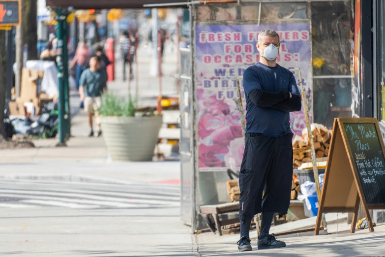 a man wearing a face mask looking away from him