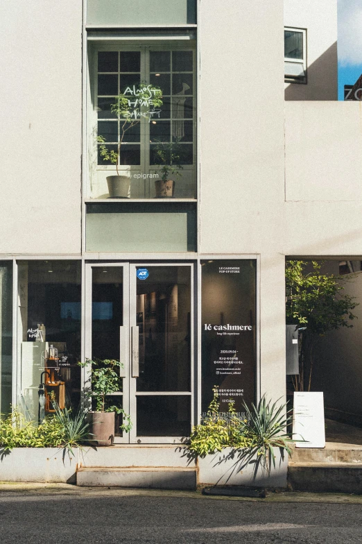 the front view of an office building with two planters