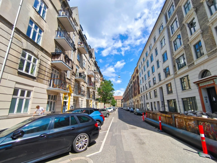 a city street with cars parked on both sides of it