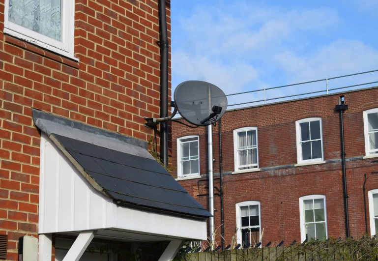 a satellite dish that is next to some houses