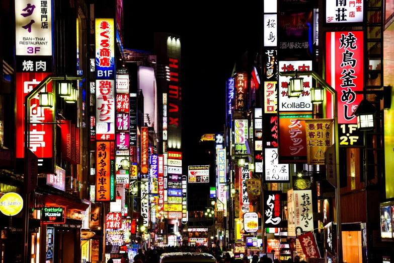 an all lit up city at night with tall buildings