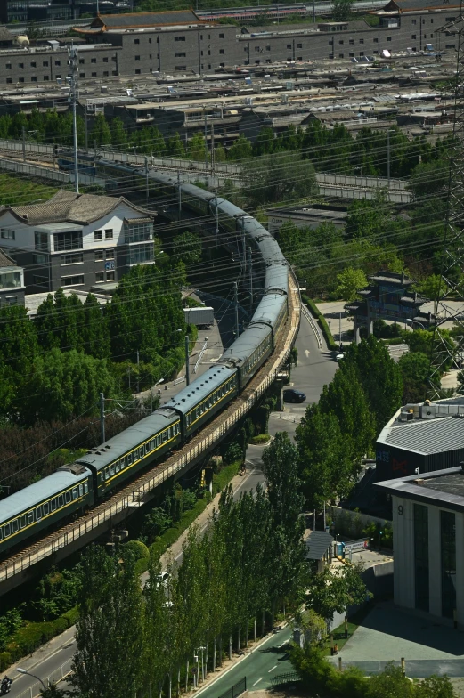 an overhead view shows a railway track next to buildings