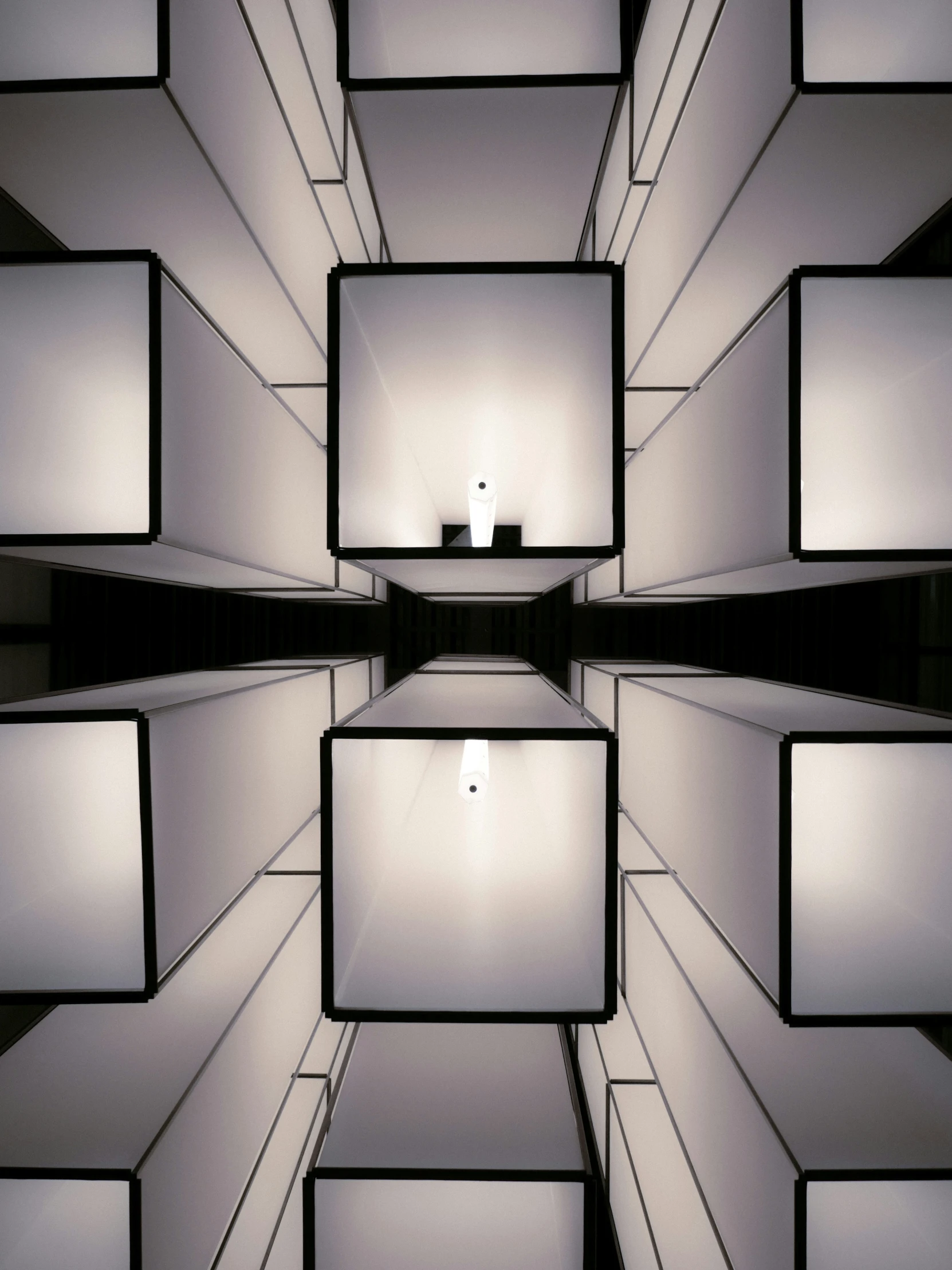 a black and white po of multiple cubes with one light