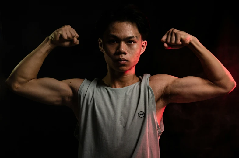 a man is flexing his muscles to the camera
