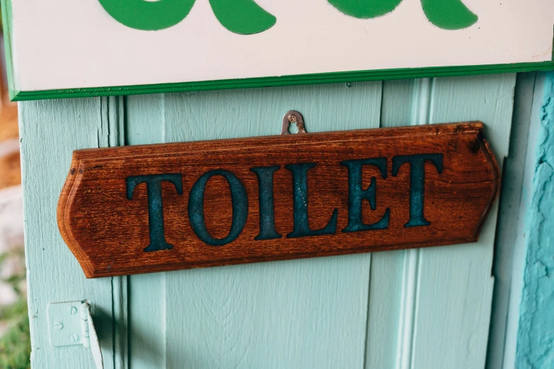 a sign that reads toilet hangs on a door