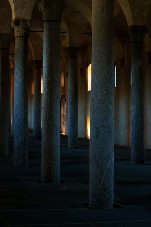 pillars lit up in an open space of columns