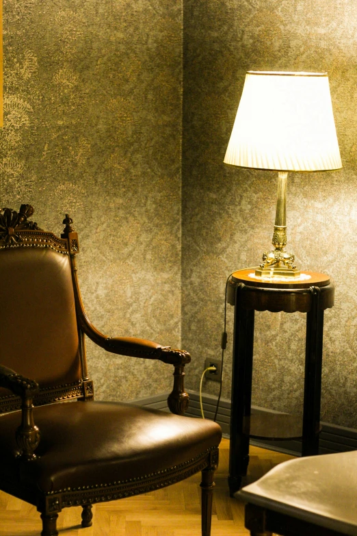 the old chair is near the bedside lamp