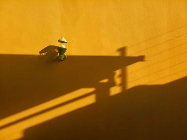 a shadow cast on the ground of a fire hydrant