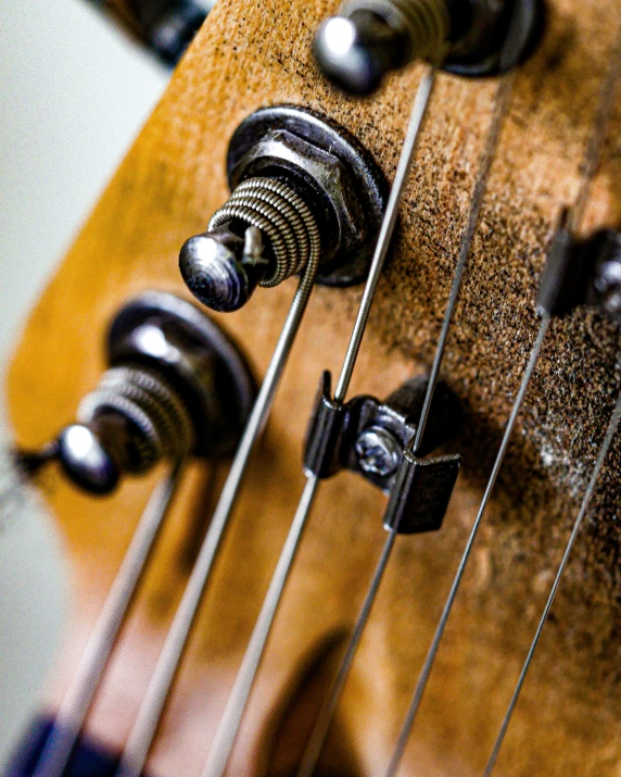 an old wooden guitar with metallic s on top