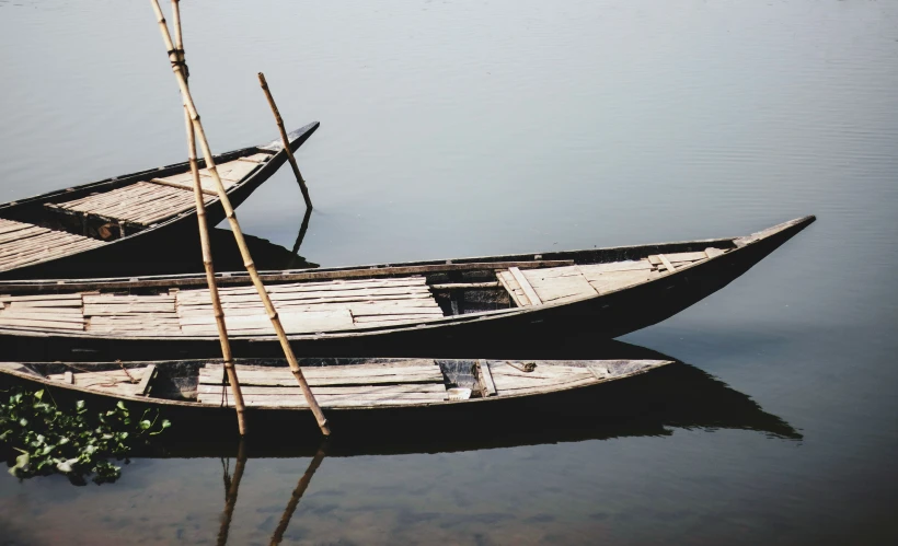 several boats sitting in the water next to each other