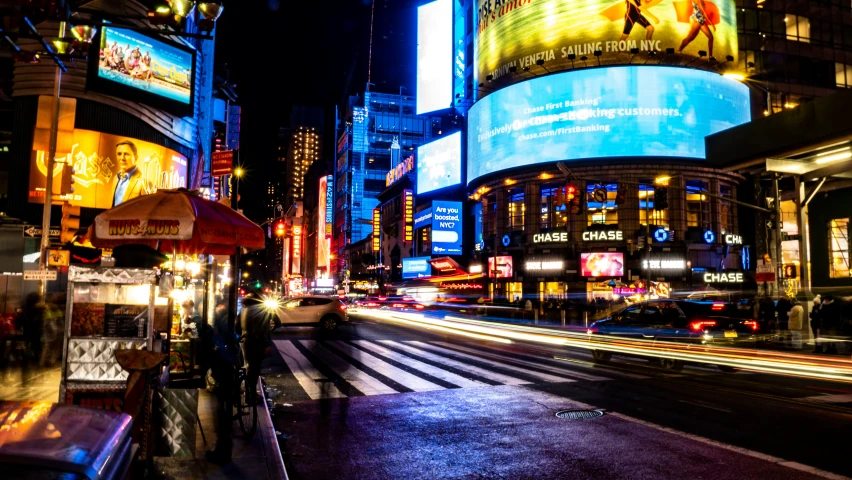 a busy intersection with traffic at night time