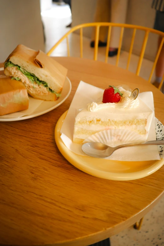 two plates filled with sandwiches on top of a table