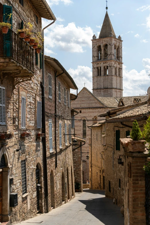 a small stone alley with an old building